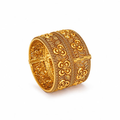Decorative gold bracelet in a wooden box with orange flowers