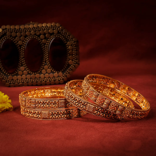 Decorative gold bangles on a red background